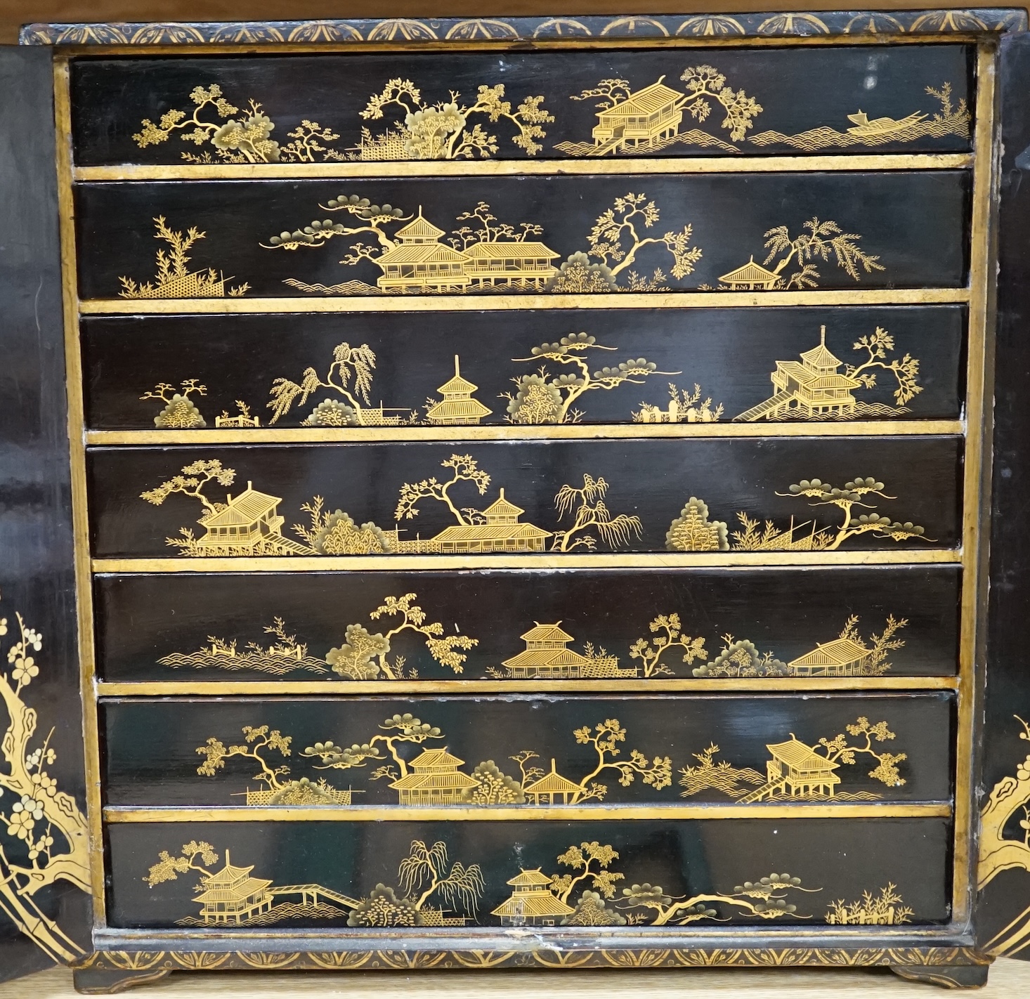 A 19th century Japanese gilt lacquered table cabinet, 38cm tall. Condition - fair